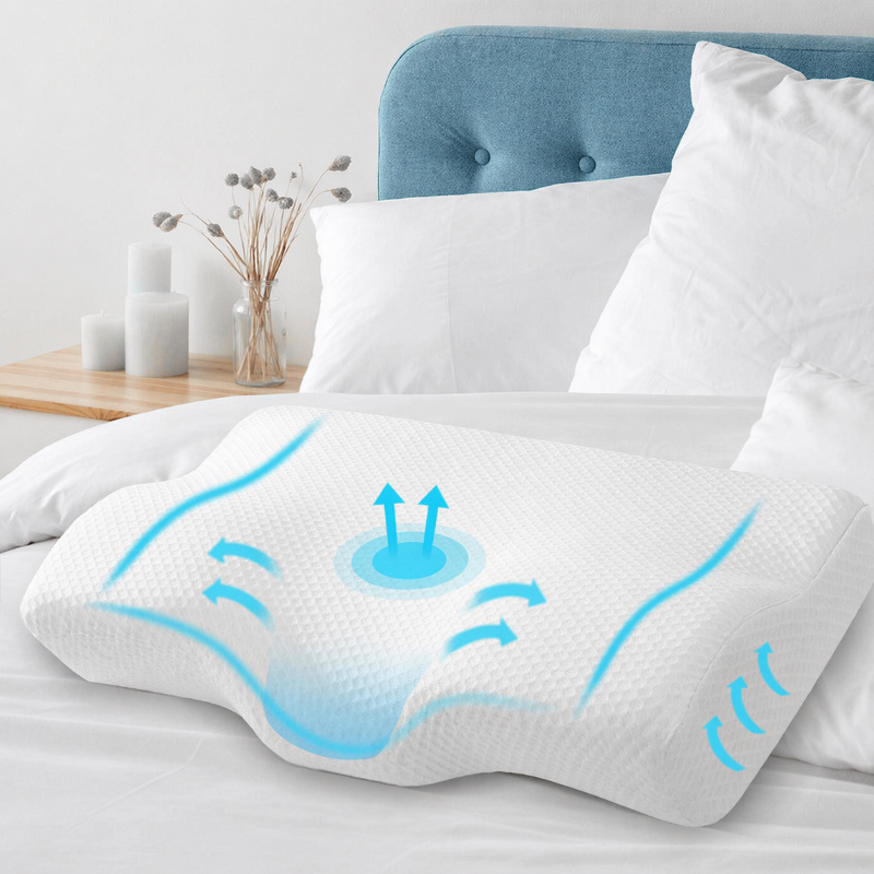 White pillow with blue moisture management graphics on a bed in a bedroom setting.